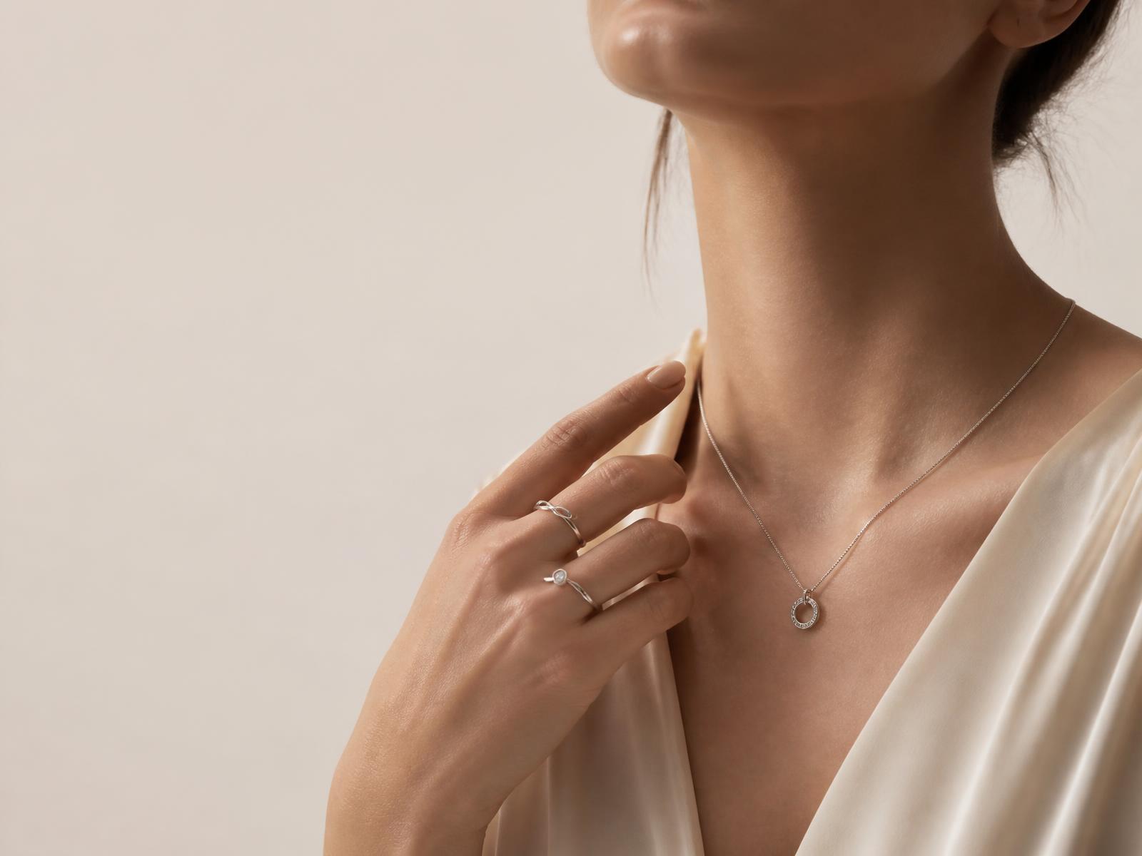 Model wearing 925 sterling silver necklace and rings